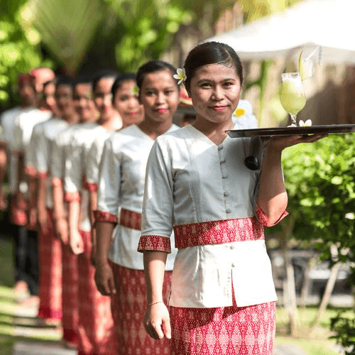 The Anam Villa team welcoming guests at the poolside gazebo