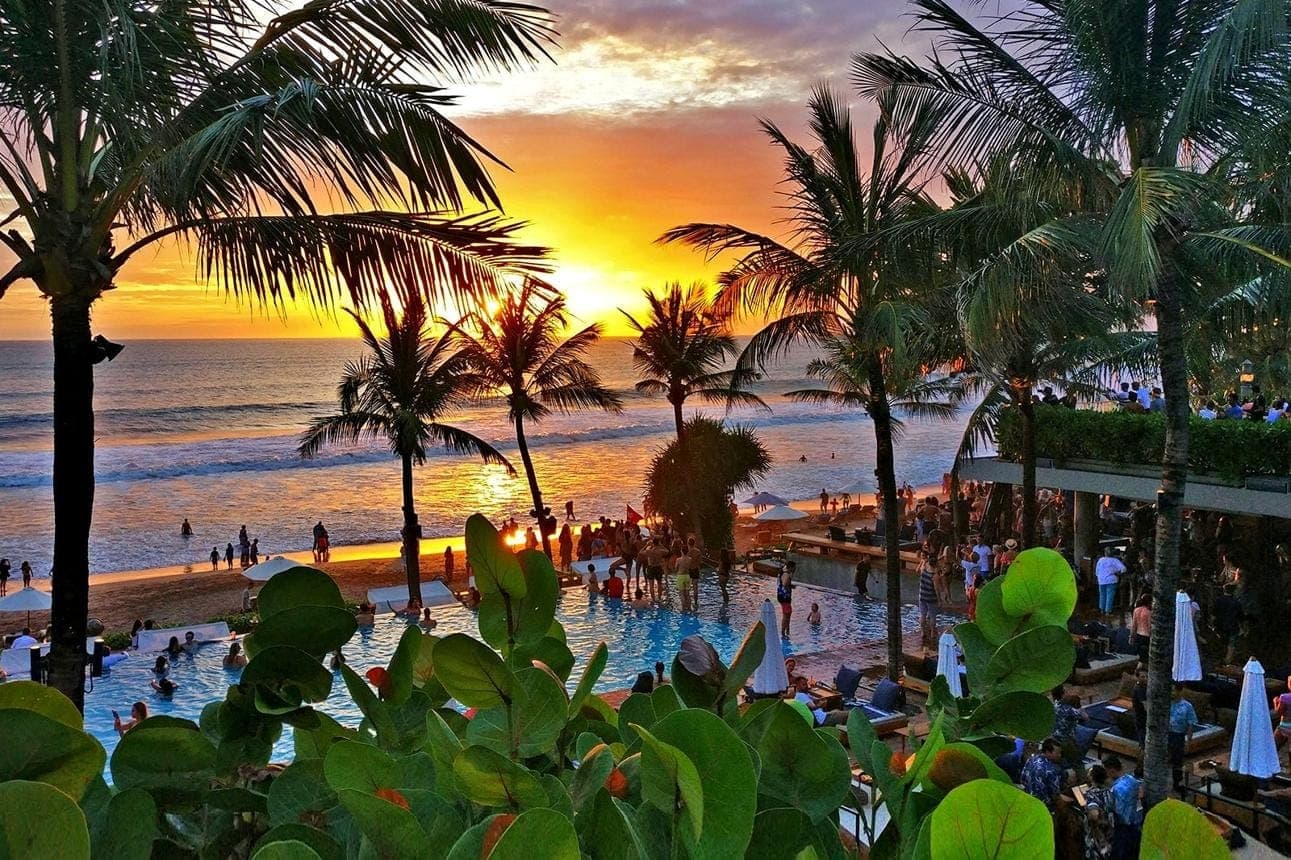 Sunset over the pool at Potato Head Beach Club